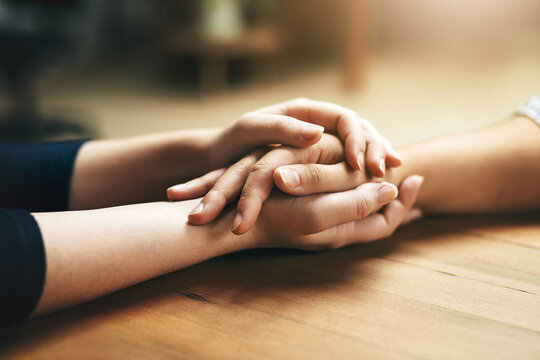 Two hands clasped together, representing forgiveness and moving forward.